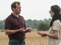 Man and woman talking in farm field