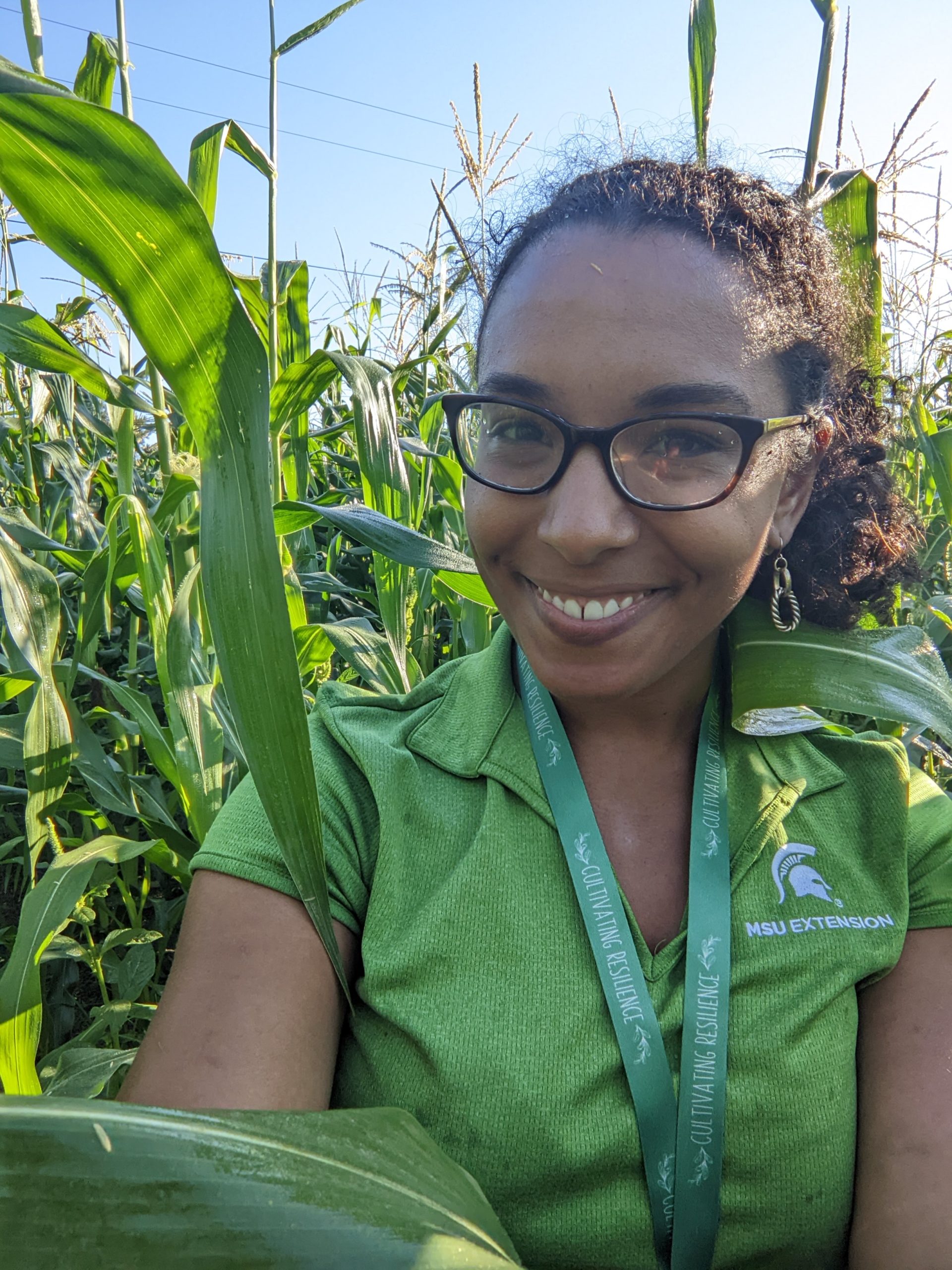 Headshot of Christine Charles in a corn field in the summer